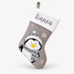 Gray Christmas stocking with name and penguin
