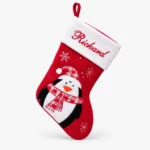 Red and white Christmas stocking with name and penguin