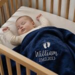 Blue personalized baby blanket in crib, lifestyle image